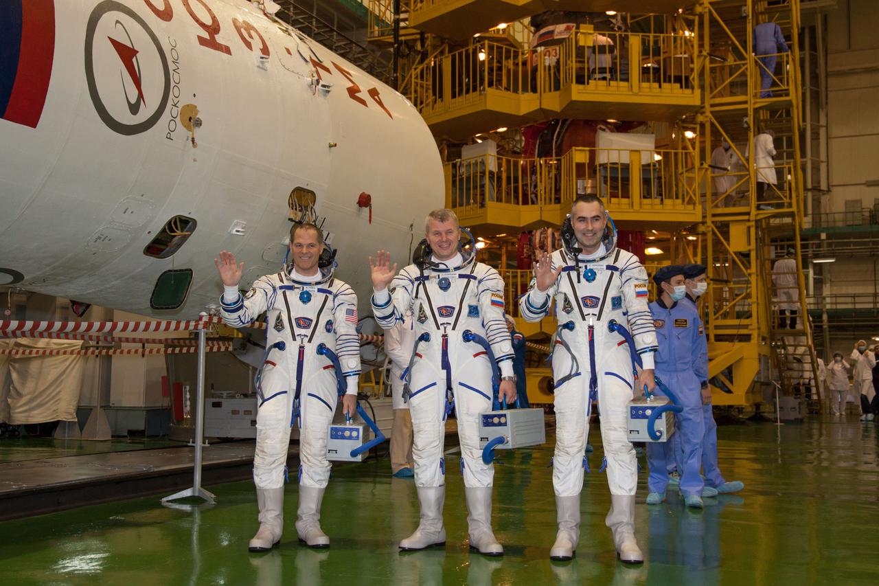 At the Baikonur Cosmodrome in Kazakhstan, the Expedition 33/34 crew posed for pictures October 10, 2012 next to the upper stage of the Soyuz rocket that will boost them and their Soyuz TMA-06M spacecraft to orbit October 23 to begin a five-month mission on the International Space Station. NASA Flight Engineer Kevin Ford (left), Soyuz Commander Oleg Novitskiy (center) and Flight Engineer Evgeny Tarelkin (right) took a break in the first of two so-called “fit check” dress rehearsal sessions as they entered the final phase of their training for launch. NASA/Victor Zelentsov