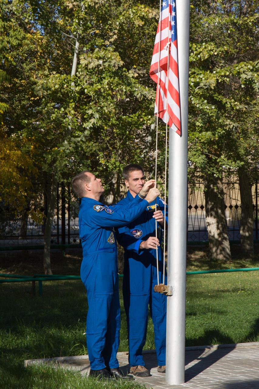 Expedition 33/34 prime Flight Engineer Kevin Ford of NASA (left) and his backup, NASA’s Chris Cassidy raise the U.S. flag outside their Cosmonaut Hotel crew quarters in Baikonur, Kazakhstan October 11, 2012. The raising of the U.S., Russian and Kazakh flags by Ford, Cassidy, prime Soyuz Commander Oleg Novitskiy, prime Flight Engineer Evgeny Tarelkin, backup Flight Engineer Alexander Misurkin and backup Soyuz Commander Pavel Vinogradov were part of the activities leading up to the scheduled launch of Ford, Novitskiy and Tarelkin October 23 in their Soyuz TMA-06 spacecraft for a five-month mission on the International Space Station. NASA/Victor Zelentsov
