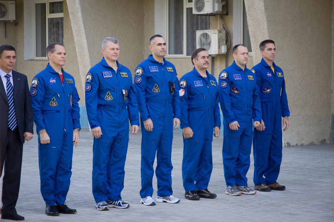 The Expedition 33/34 prime and backup crewmembers participated in ceremonies outside their Cosmonaut Hotel crew quarters in Baikonur, Kazakhstan October 11, 2012 highlighted by the traditional raising of the flags of the United States, Russia and Kazakhstan. Pictured from left to right are an unidentified local Kazakh official, Expedition 33/34 Flight Engineer Kevin Ford of NASA, prime Soyuz Commander Oleg Novitskiy, prime Flight Engineer Evgeny Tarelkin, backup Soyuz Commander Pavel Vinogradov. backup Flight Engineer Alexander Misurkin and backup Flight Engineer Chris Cassidy of NASA. Ford, Novitskiy and Tarelkin are scheduled to launch October 23 in their Soyuz TMA-06 spacecraft for a five-month mission on the International Space Station. NASA/Victor Zelentsov