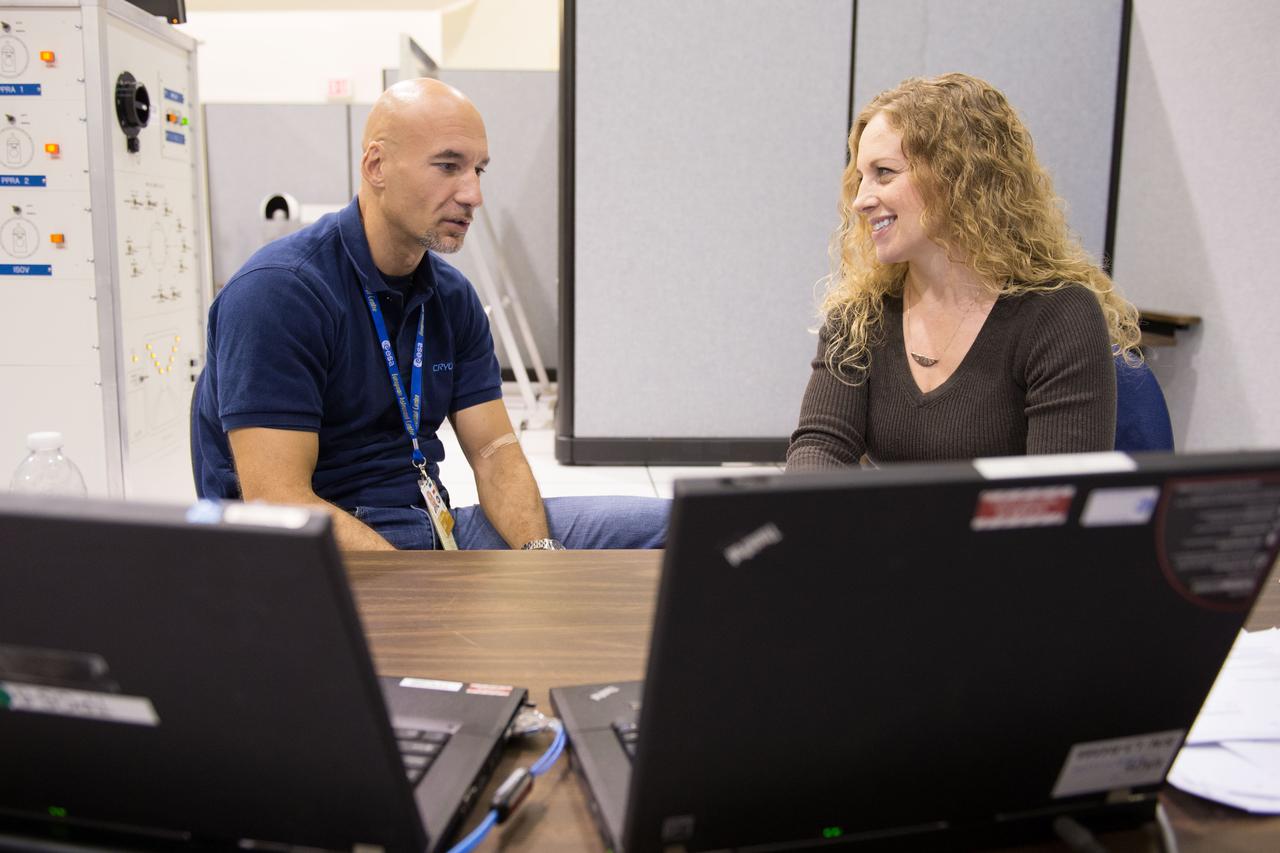 Date: 10-16-12 Location: Bldg 5, SSTF Subject: Expedition 37 (Soyuz 35) ESA astronaut Luca Parmitano during Columbus Reactivation training with instructor Michaela Benda in the crew station, Node-2 area sitting at a table and working on laptops Photographer: James Blair