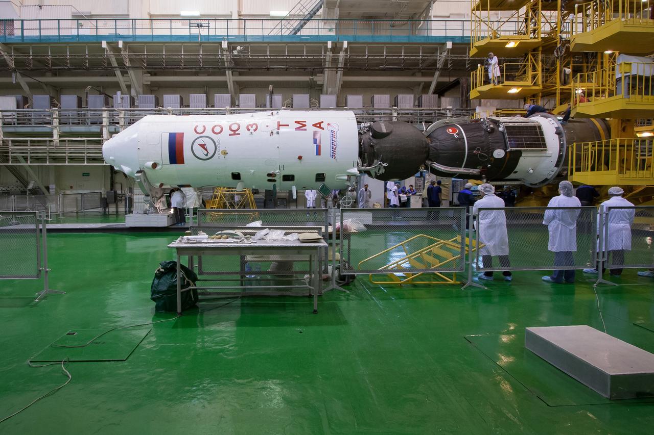 At the Integration Facility at the Baikonur Cosmodrome in Kazakhstan, the Soyuz TMA-06M spacecraft is inserted into the upper stage of its Soyuz booster rocket October 16, 2012. The Soyuz is being prepared for launch October 23 to the International Space Station with NASA Flight Engineer Kevin Ford, Soyuz Commander Oleg Novitskiy and Flight Engineer Evgeny Tarelkin for a five-month mission on the orbital laboratory. NASA/Victor Zelentsov