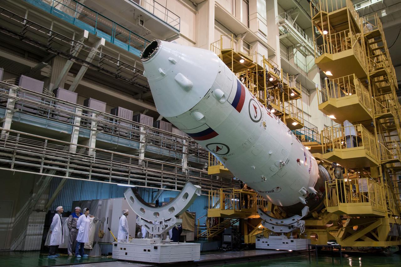 With the Soyuz TMA-06M spacecraft safely installed inside, the upper stage of its Soyuz booster rocket is rotated to the vertical position in the Integration Facility at the Baikonur Cosmodrome in Kazakhstan October 16, 2012. The Soyuz is being prepared for launch October 23 to the International Space Station with NASA Flight Engineer Kevin Ford, Soyuz Commander Oleg Novitskiy and Flight Engineer Evgeny Tarelkin for a five-month mission on the orbital laboratory. NASA/Victor Zelentsov