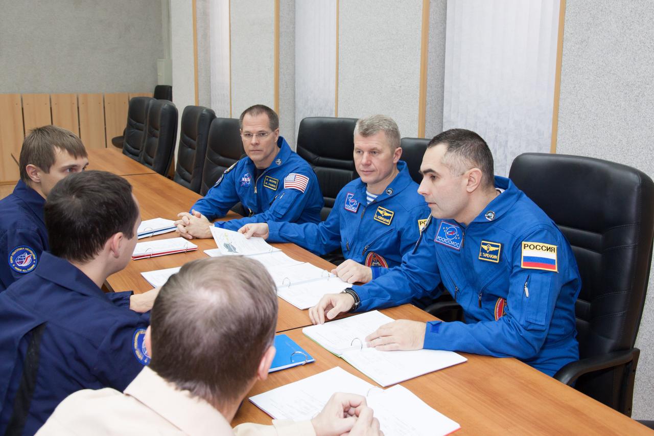 At their Cosmonaut Hotel crew quarters in Baikonur, Kazakhstan, Expedition 33/34 Flight Engineer Kevin Ford of NASA (left), Soyuz Commander Oleg Novitskiy (center) and Flight Engineer Evgeny Tarelkin (right) review docking procedures with their Gagarin Cosmonaut Training Center instructors October 17, 2012 as they prepare for launch October 23 to the International Space Station in their Soyuz TMA-06M spacecraft. The trio will spend five months on the orbital laboratory. NASA/Victor Zelentsov