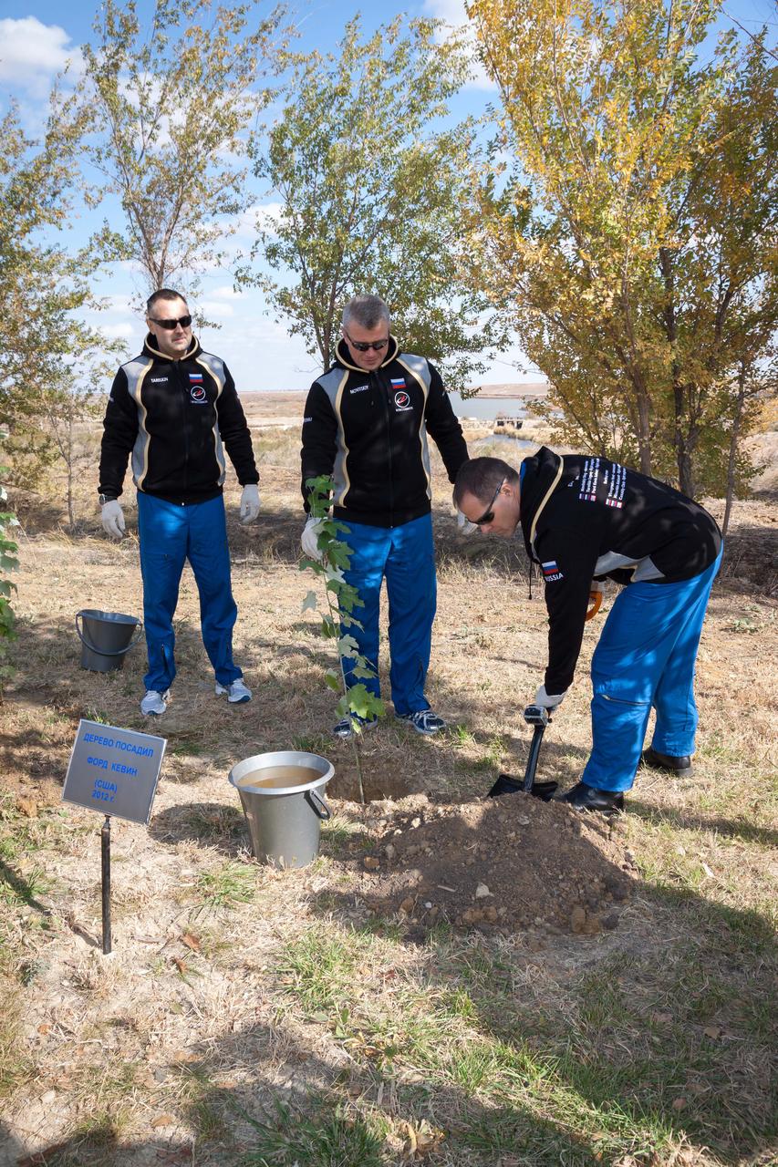 Fulfilling a long-standing pre-launch tradition, Expedition 33/34 Flight Engineer Kevin Ford of NASA (right) plants a tree in his name behind the Cosmonaut Hotel crew quarters in Baikonur, Kazakhstan October 17, 2012. Ford, Flight Engineer Evgeny Tarelkin (left) and Soyuz Commander Oleg Novitskiy(center) are preparing for launch October 23 in their Soyuz TMA-06M spacecraft to spend five months on the International Space Station. NASA/Victor Zelentsov
