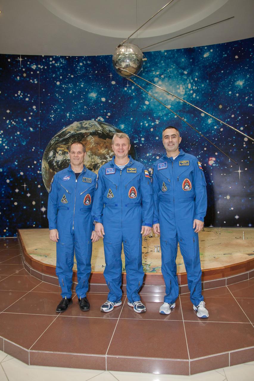 Expedition 33/34 Flight Engineer Kevin Ford of NASA (left), Soyuz Commander Oleg Novitskiy (center) and Flight Engineer Evgeny Tarelkin (right) pose for pictures in front of a model of Sputnik 1, the world’s first artificial satellite, in the Korolev Museum at the Baikonur Cosmodrome in Kazakhstan October 18, 2012. The trio completed a final “fit check” dress rehearsal, preparing for launch October 23 in their Soyuz TMA-06M spacecraft from the Cosmodrome for a five-month mission on the International Space Station. NASA/Victor Zelentsov