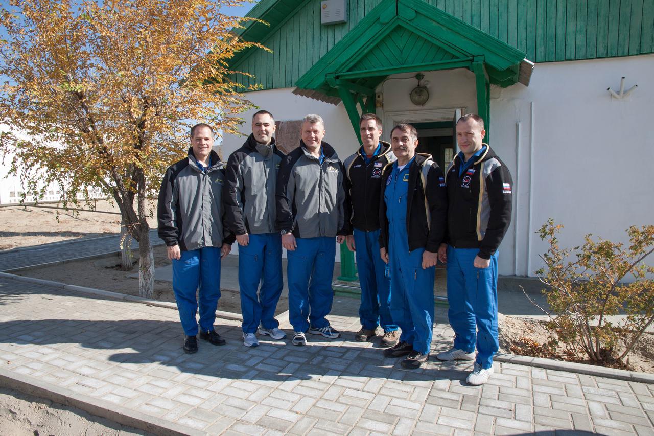 The Expedition 33/34 prime and backup crews pose for pictures October 18, 2012 at the Baikonur Cosmodrome in Kazakhstan in front of the famed cottage where Yuri Gagarin slept the night before his launch April 12, 1961 aboard the Vostok 1 spacecraft to become the first human to fly in space. From left to right are prime NASA Flight Engineer Kevin Ford, prime Flight Engineer Evgeny Tarelkin, prime Soyuz Commander Oleg Novitskiy and backup crewmembers Chris Cassidy of NASA, Pavel Vinogradov and Alexander Misurkin. Ford, Novitskiy and Tarelkin will launch October 23 from the Cosmodrome in their Soyuz TMA-06M spacecraft for a five-month mission on the International Space Station. NASA/Victor Zelentsov
