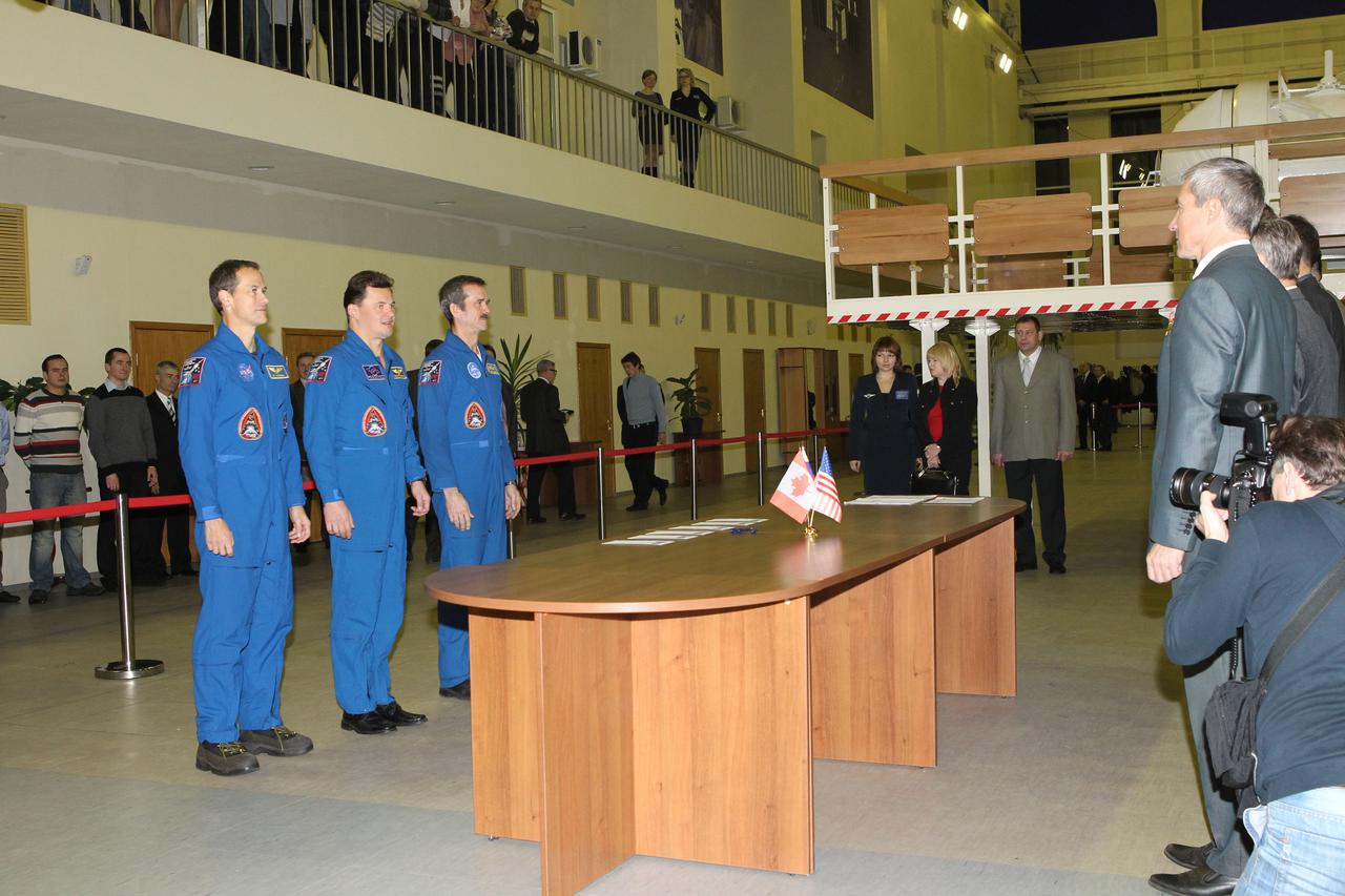 At the Gagarin Cosmonaut Training Center (GCTC) in Star City, Russia, the next trio of residents to be launched to the International Space Station began two days of certification exams for flight Nov. 27, 2012. Expedition 34/35 NASA Flight Engineer Tom Marshburn (left), Soyuz Commander Roman Romanenko (center) and Flight Engineer Chris Hadfield of the Canadian Space Agency received preliminary instructions from GCTC Director Sergei Krikalev (far right). Romanenko, Marshburn and Hadfield and their backups are in the final weeks of training for launch on the Soyuz TMA-07M spacecraft from the Baikonur Cosmodrome in Kazakhstan on Dec. 19 for 5 ½ months on the orbital laboratory. NASA/Stephanie Stoll