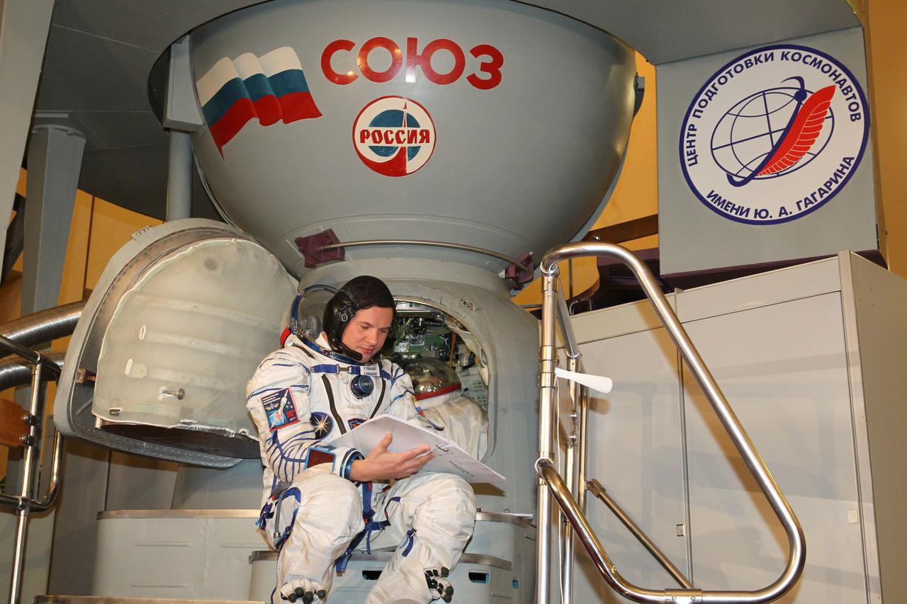 At the Gagarin Cosmonaut Training Center in Star City, Russia, Expedition 34/35 Soyuz Commander Roman Romanenko studies a flight data file manual in front of a Soyuz spacecraft simulator Nov. 28, 2012 as he and his crewmates conducted the second of two days of flight qualification exams. Romanenko, NASA Flight Engineer Tom Marshburn and Flight Engineer Chris Hadfield of the Canadian Space Agency are scheduled to launch Dec. 19 from the Baikonur Cosmodrome in Kazakhstan on the Soyuz TMA-07M spacecraft, bound for a 5-month mission on the International Space Station. NASA/Stephanie Stoll