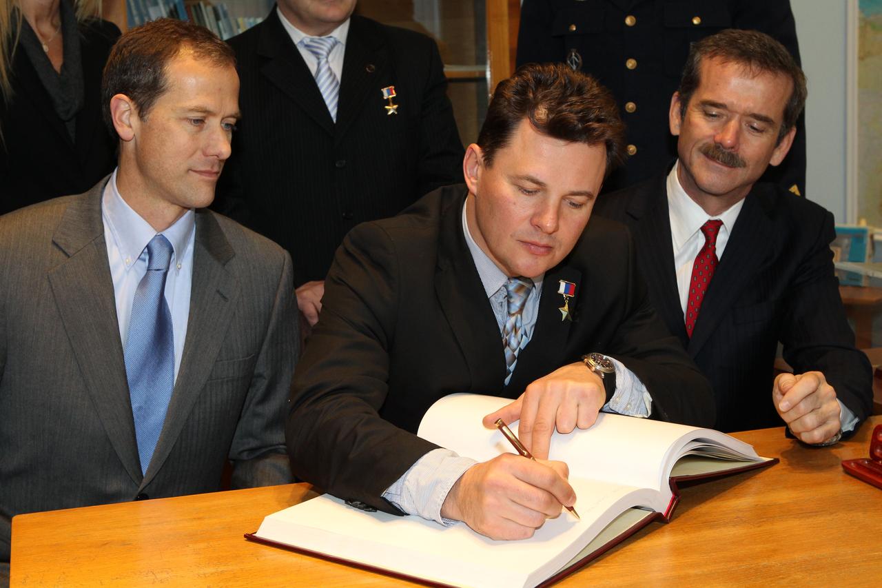 At the Gagarin Museum at the Gagarin Cosmonaut Training Center in Star City, Russia, Expedition 34/35 Soyuz Commander Roman Romanenko (center) signs a testimonial book Nov. 29, 2012 during ceremonial activities. The book is signed by all Russian and international space travelers prior to their flights. Looking on are NASA Flight Engineer Tom Marshburn (left) and Flight Engineer Chris Hadfield of the Canadian Space Agency (right). They are scheduled to launch Dec. 19 to the International Space Station in the Soyuz TMA-07M spacecraft from the Baikonur Cosmodrome in Kazakhstan. NASA/Stephanie Stoll