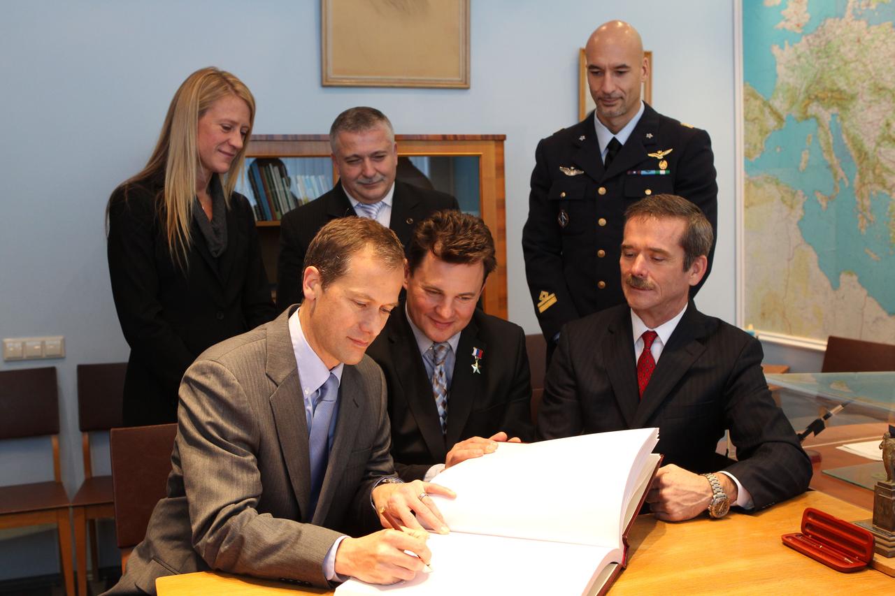 At the Gagarin Museum at the Gagarin Cosmonaut Training Center in Star City, Russia, Expedition 34/35 Flight Engineer Tom Marshburn of NASA (left) signs a testimonial book Nov. 29, 2012 during ceremonial activities. The book is signed by all Russian and international space travelers prior to their flights. Looking on are Soyuz Commander Roman Romanenko (front center), and Flight Engineer Chris Hadfield of the Canadian Space Agency (front right). In the back row are their backups, NASA’s Karen Nyberg (left), Fyodor Yurchikhin (center) and Luca Parmitano of the European Space Agency (right). Marshburn, Romanenko and Hadfield are scheduled to launch Dec. 19 to the International Space Station in the Soyuz TMA-07M spacecraft from the Baikonur Cosmodrome in Kazakhstan. NASA/Stephanie Stoll