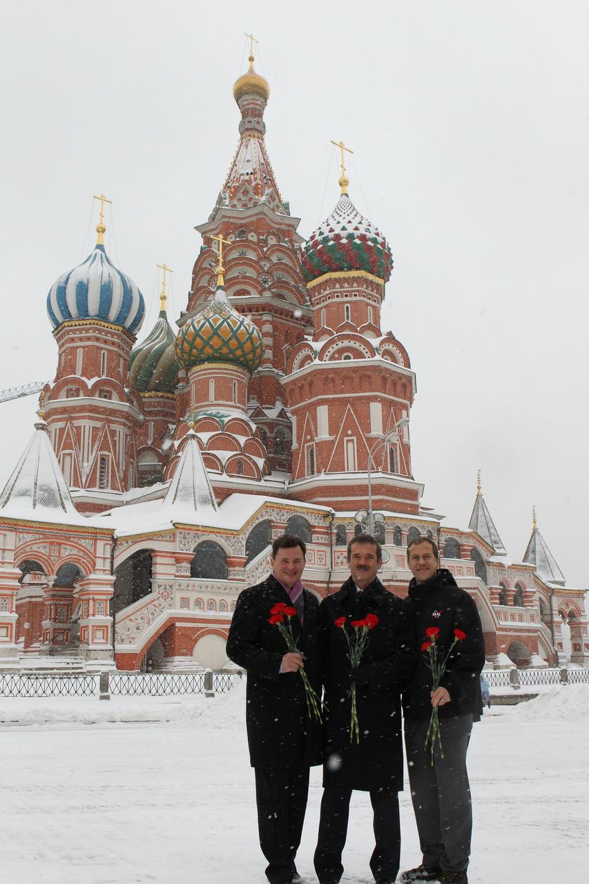 Expedition 34/35 Soyuz Commander Roman Romanenko (left), Flight Engineer Chris Hadfield of the Canadian Space Agency (center) and Flight Engineer Tom Marshburn of NASA pose for pictures in front of St. Basil’s Cathedral in Moscow Nov. 29, 2012 during a tour of Red Square during which they laid flowers at the Kremlin Wall where Russian space heroes are interred. The trio will launch to the International Space Station Dec. 19 from the Baikonur Cosmodrome in Kazakhstan in their Soyuz TMA-07M spacecraft. NASA/Stephanie Stoll