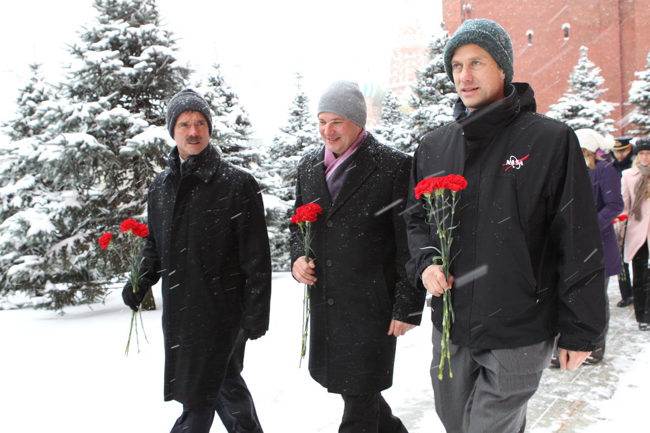 Expedition 34/35 Flight Engineer Chris Hadfield (left), Soyuz Commander Roman Romanenko (left) and Flight Engineer Tom Marshburn of NASA walk along the Kremlin Wall in Moscow Nov. 29, 2012 during a tour of Red Square during which they laid flowers where Russian space heroes are interred. The trio will launch to the International Space Station Dec. 19 from the Baikonur Cosmodrome in Kazakhstan in their Soyuz TMA-07M spacecraft. NASA/Stephanie Stoll