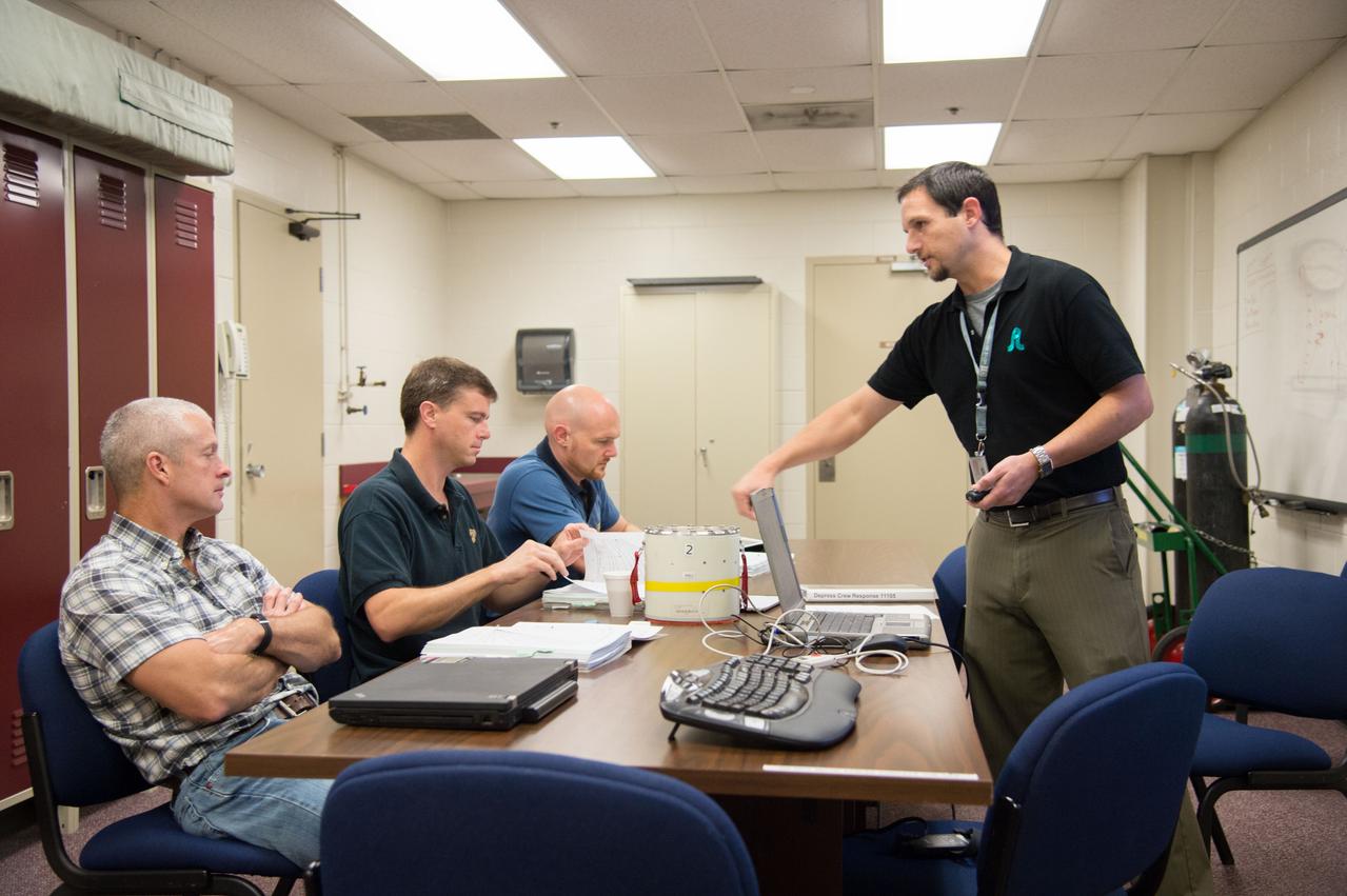 PHOTO DATE: 11-30-12 LOCATION: Bldg. 9NW - ISS SRB Mockup SUBJECT: Expedition 40 crew members (Soyuz 39) Reid Wiseman and ESA astronaut Alexander Gerst with Soyuz 38 crew member Steve Swanson during DEPRESS CREW RESPONSE/B9 SRB. PHOTOGRAPHER: BILL STAFFORD