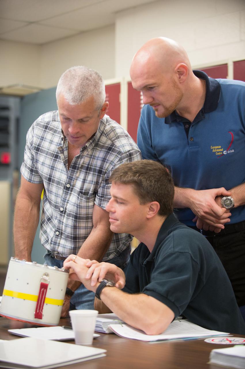 PHOTO DATE:  11-30-12 LOCATION: Bldg. 9NW - ISS SRB Mockup    SUBJECT: Expedition 40 crew members (Soyuz 39) Reid Wiseman and ESA astronaut Alexander Gerst with Soyuz 38 crew member Steve Swanson during DEPRESS CREW RESPONSE/B9 SRB. PHOTOGRAPHER: BILL STAFFORD