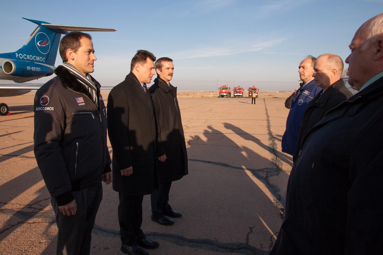 In Baikonur, Kazakhstan, Expedition 34/35 Flight Engineer Tom Marshburn of NASA (far left), Soyuz Commander Roman Romanenko (second from left) and Flight Engineer Chris Hadfield of the Canadian Space Agency (third from left) are greeted by Russian space officials upon their arrival from Star City, Russia Dec. 6, 2012 as they begin final training for their launch Dec. 19 from the Baikonur Cosmodrome on the Soyuz TMA-07M spacecraft for a five-month mission on the International Space Station. Photo Credit: NASA/Victor Zelentsov 