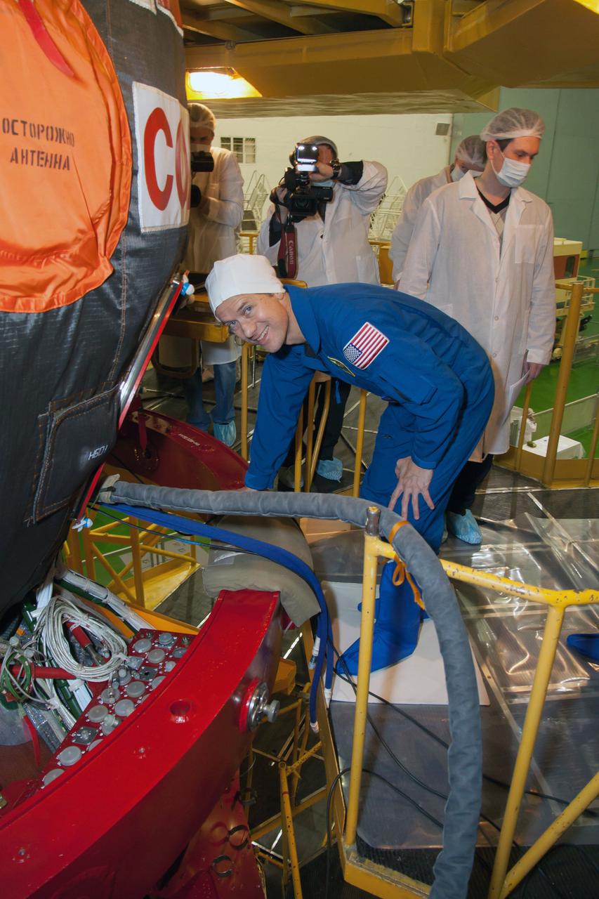 At the Baikonur Cosmodrome in Kazakhstan, Expedition 34/35 Flight Engineer Tom Marshburn of NASA poses for pictures during an inspection of the Soyuz TMA-07M spacecraft that was part of a “fit check” dress rehearsal Dec. 7, 2012. Marshburn, Soyuz Commander Roman Romanenko and Flight Engineer Chris Hadfield of the Canadian Space Agency will launch from Baikonur Dec. 19 for a five-month mission on the International Space Station. Photo Credit: NASA/Victor Zelentsov
