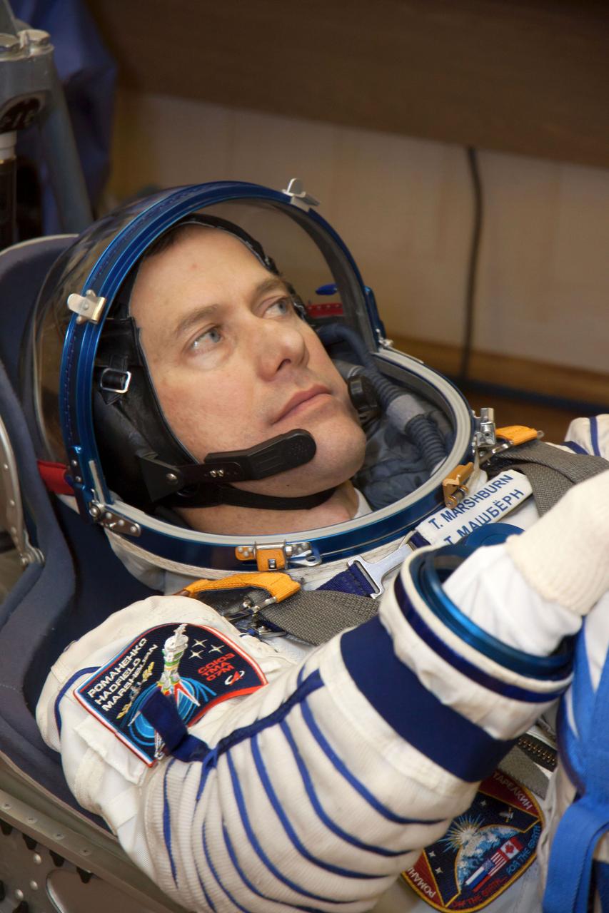At the Baikonur Cosmodrome in Kazakhstan, Expedition 34/35 Flight Engineer Tom Marshburn of NASA strikes a serious pose during leak checks of his Russian Sokol launch and entry suit Dec. 7, 2012, part of a “fit check” dress rehearsal for launch in the Soyuz TMA-07M spacecraft. Marshburn, Soyuz Commander Roman Romanenko and Flight Engineer Chris Hadfield of the Canadian Space Agency will launch Dec. 19 for a five-month mission on the International Space Station. Photo Credit: NASA/Victor Zelentsov