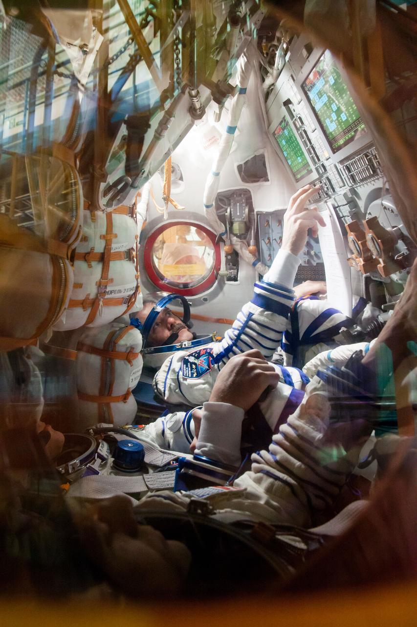 At the Baikonur Cosmodrome in Kazakhstan, Expedition 34/35 Soyuz Commander Roman Romanenko (foreground) and Flight Engineer Chris Hadfield of the Canadian Space Agency conduct a “fit check” dress rehearsal inside the Soyuz TMA-07M spacecraft Dec. 7, 2012. Along with Flight Engineer Tom Marshburn of NASA (not pictured), Romanenko and Hadfield are preparing for launch Dec. 19 for a five-month mission on the International Space Station. Photo Credit: NASA/Victor Zelentsov