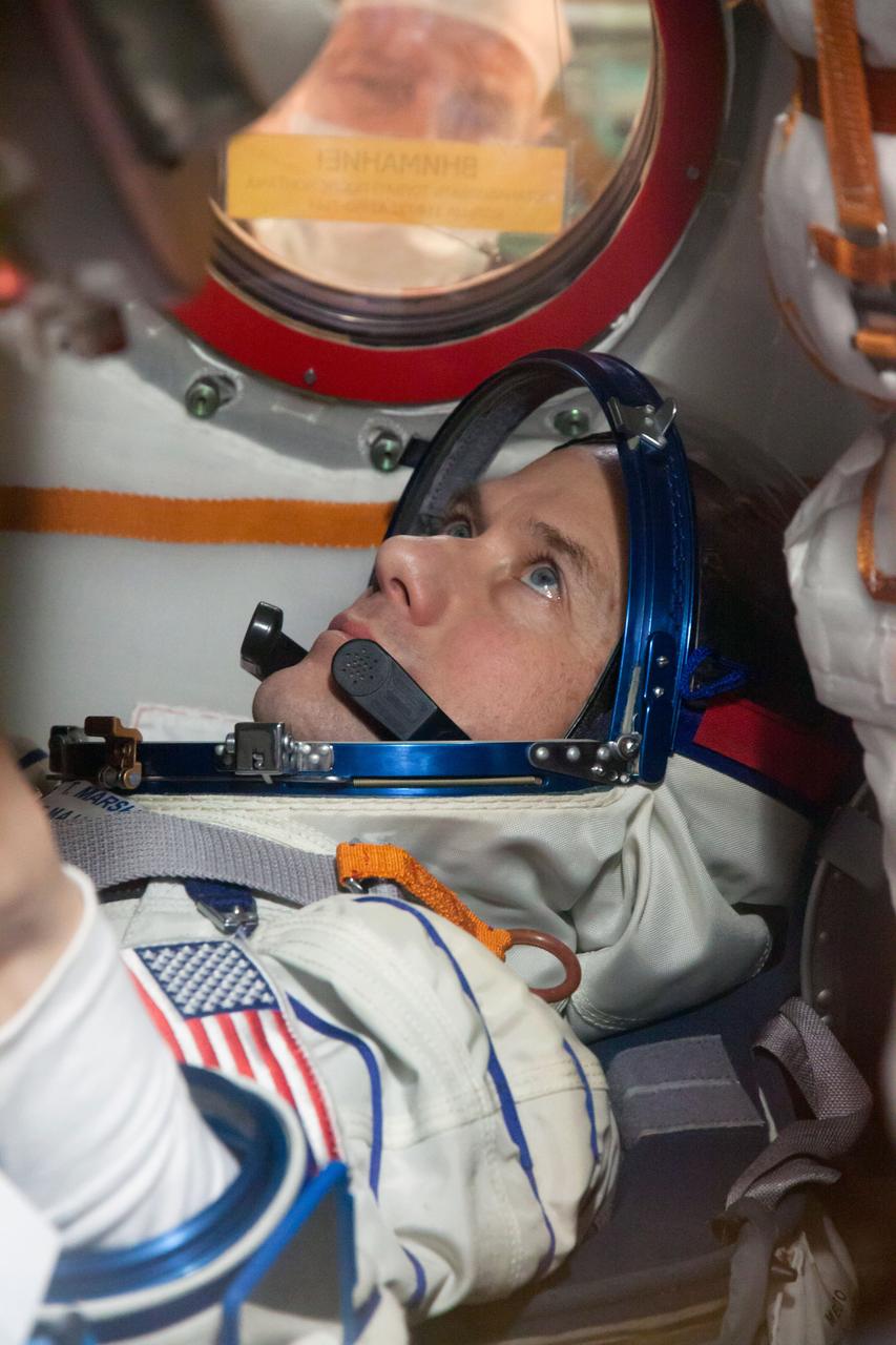 At the Baikonur Cosmodrome in Kazakhstan, Expedition 34/35 Flight Engineer Tom Marshburn of NASA conducts a “fit check” dress rehearsal inside the Soyuz TMA-07M spacecraft Dec. 7, 2012. Along with Soyuz Commander Roman Romanenko and Flight Engineer Chris Hadfield of the Canadian Space Agency, who are not pictured, Marshburn is preparing for launch Dec. 19 for a five-month mission on the International Space Station. Photo Credit: NASA/Victor Zelentsov