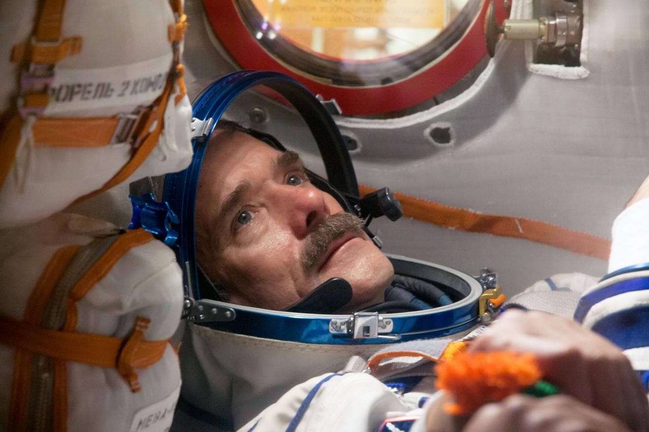 At the Baikonur Cosmodrome in Kazakhstan, Expedition 34/35 Flight Engineer Chris Hadfield of the Canadian Space Agency conducts a “fit check” dress rehearsal inside the Soyuz TMA-07M spacecraft Dec. 7, 2012. Along with Soyuz Commander Roman Romanenko and Flight Engineer Tom Marshburn of NASA, who are not pictured, Hadfield is preparing for launch Dec. 19 for a five-month mission on the International Space Station. Photo Credit: NASA/Victor Zelentsov
