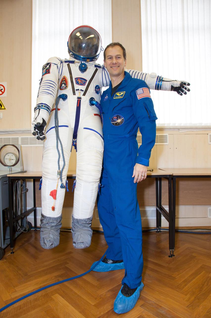 At the Baikonur Cosmodrome in Kazakhstan, Expedition 34/35 Flight Engineer Tom Marshburn of NASA strikes a playful pose with his Sokol launch and entry suit Dec. 7, 2012 during a “fit check” dress rehearsal. Marshburn, Soyuz Commander Roman Romanenko and Flight Engineer Chris Hadfield of the Canadian Space Agency are preparing for launch Dec. 19 in their Soyuz TMA-07M spacecraft for a five-month mission on the International Space Station. Photo Credit: NASA/Victor Zelentsov