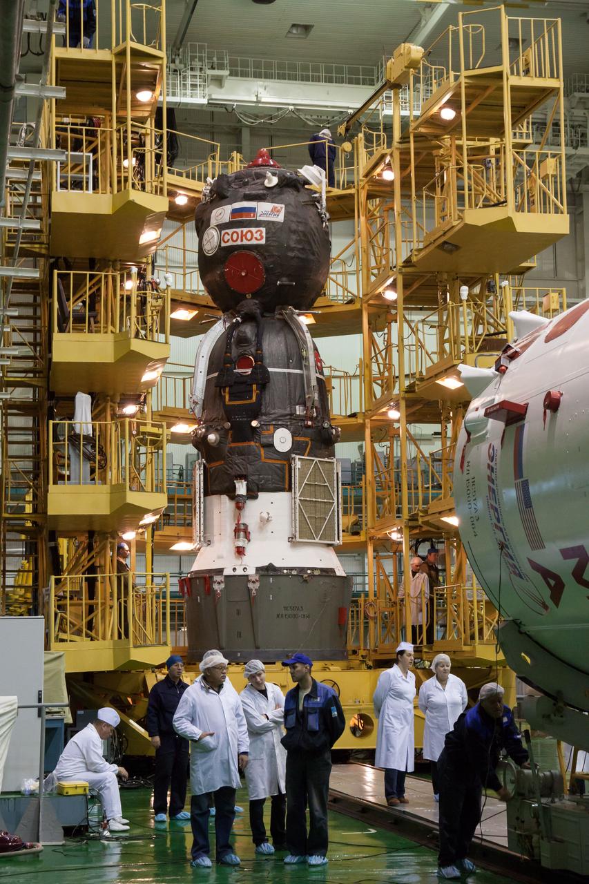 In the Integration Facility at the Baikonur Cosmodrome in Kazakhstan, the Soyuz TMA-07M spacecraft is prepared for its encapsulation into the upper stage of the Soyuz booster Dec. 12, 2012 as preparations continue for the launch of the Expedition 34/35 crew. The vehicle will be rolled to the launch pad at Baikonur Dec. 17 in advance of the Dec. 19 launch of NASA Flight Engineer Tom Marshburn, Soyuz Commander Roman Romanenko and Flight Engineer Chris Hadfield of the Canadian Space Agency for a five-month mission on the International Space Station. Photo Credit: NASA/Victor Zelentsov