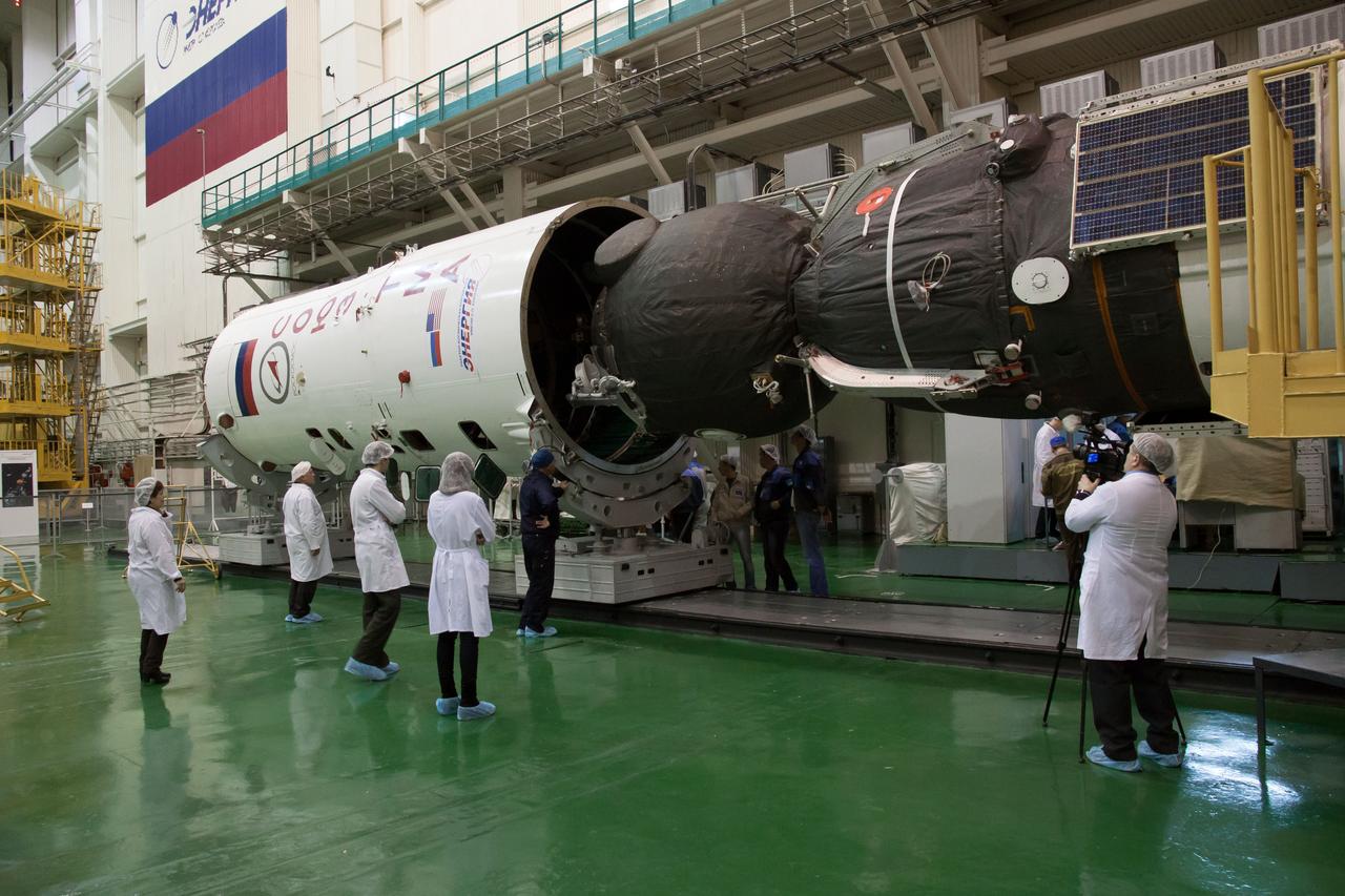 In the Integration Facility at the Baikonur Cosmodrome in Kazakhstan, the Soyuz TMA-07M spacecraft is encapsulated into the upper stage of the Soyuz booster Dec. 12, 2012 as preparations continue for the launch of the Expedition 34/35 crew. The vehicle will be rolled to the launch pad at Baikonur Dec. 17 in advance of the Dec. 19 launch of NASA Flight Engineer Tom Marshburn, Soyuz Commander Roman Romanenko and Flight Engineer Chris Hadfield of the Canadian Space Agency for a five-month mission on the International Space Station. Photo Credit: NASA/Victor Zelentsov