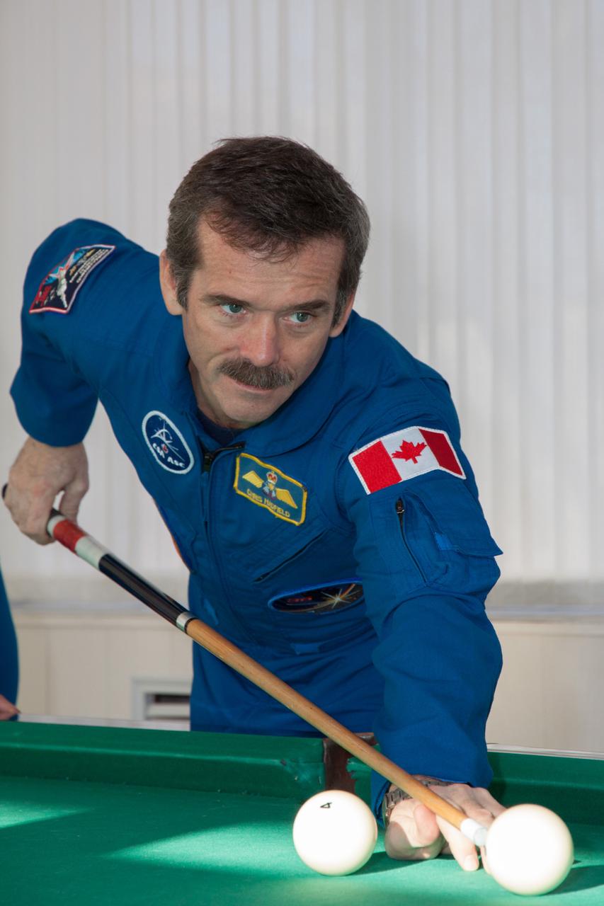 At the Cosmonaut Hotel crew quarters in Baikonur, Kazakhstan, Expedition 34/35 Flight Engineer Chris Hadfield of the Canadian Space Agency plays a game of pool Dec. 13, 2012 as he prepares for launch Dec. 19 on the Soyuz TMA-07M spacecraft from the Baikonur Cosmodrome on a five-month mission to the International Space Station with NASA Flight Engineer Tom Marshburn and Soyuz Commander Roman Romanenko. NASA/Victor Zelentsov