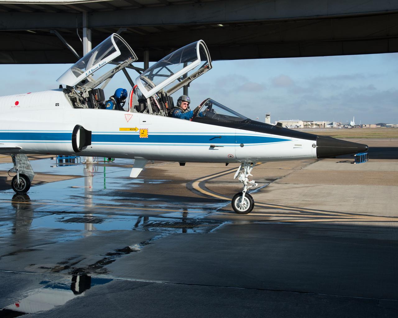 PHOTO DATE:  02-07-13 LOCATION:  Ellington Field - Hangar 276 - Tarmac  SUBJECT: Scott Kelly during T-38 flight prep and getting into aircraft along with Stephanie Wilson. PHOTOGRAPHER:  BILL STAFFORD