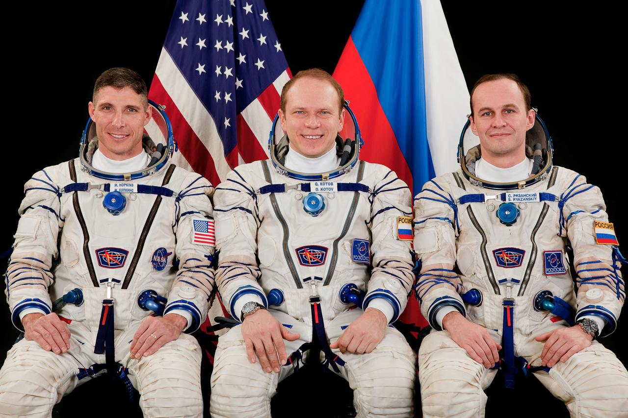 JSC2013-E-013369 (February 2013) --- Portrait of Expedition 35 backup crew, attired in their Russian Sokol launch and entry suits. Soyuz Commander Oleg Kotov (center) is flanked by backup Flight Engineers Mike Hopkins (left) of NASA and Sergei Ryazanskiy of Roscosmos. Photo credit: Gagarin Cosmonaut Training Center