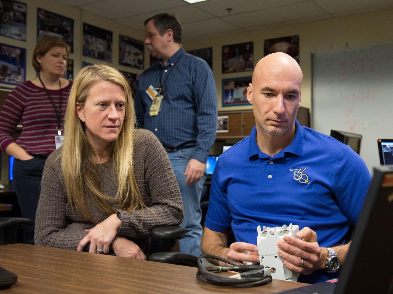 Expedition 36/37 crew members Luca Parmitano and Karen Nyberg during  SAFER training in the VR Lab