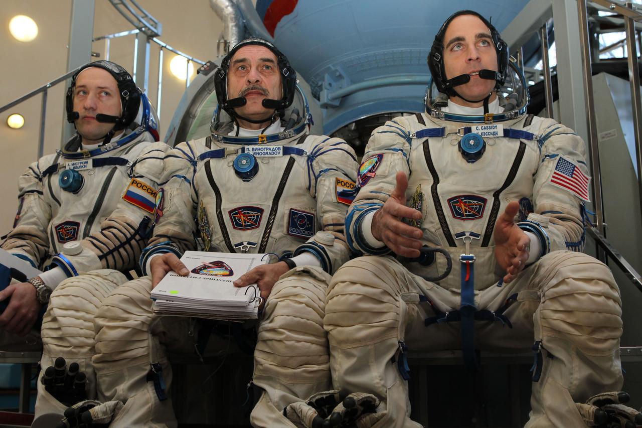 At the Gagarin Cosmonaut Training Center in Star City, Russia, Expedition 35-36 Flight Engineer Chris Cassidy (right) answers questions from reporters prior to the start of qualification simulation runs in a Soyuz spacecraft mockup March 5. Cassidy, Soyuz Commander Pavel Vinogradov (center) and Flight Engineer Alexander Misurkin (left) are training for launch March 29, Kazakh time, to the International Space Station in their Soyuz TMA-08M spacecraft from the Baikonur Cosmodrome in Kazakhstan. NASA / Stephanie Stoll