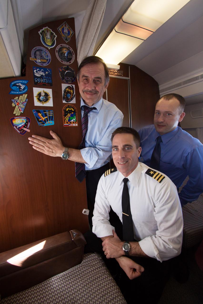 Aboard a Russian Federal Space Agency aircraft carrying them to their launch site, Expedition 35-36 Soyuz Commander Pavel Vinogradov (left), Flight Engineer Chris Cassidy of NASA (center) and Flight Engineer Alexander Misurkin displayed their mission stickers (far left column on the cabin wall) March 16 as they flew from their training base in Star City, Russia to Baikonur, Kazakhstan for final training for their launch to the International Space Station on March 29, Kazakh time, in their Soyuz TMA-08M spacecraft from the Baikonur Cosmodrome. NASA/Victor Zelentsov