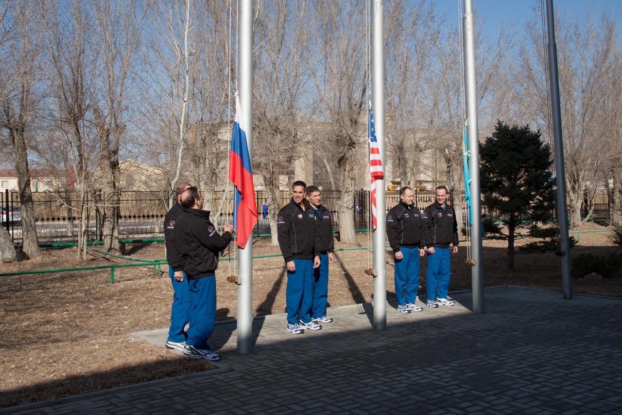 At their Cosmonaut Hotel crew quarters in Baikonur, Kazakhstan, the Expedition 35-36 prime and backup crewmembers prepare to hoist the flags of Russia, the United States and Kazakhstan March 18 during traditional ceremonies. From left to right are backup crewmember Oleg Kotov (partially hidden), prime crewmember Pavel Vinogradov, prime NASA crewmember Chris Cassidy, his backup, Michael Hopkins of NASA, prime crewmember Alexander Misurkin and his backup, Sergey Ryazanskiy. Cassidy, Vinogradov and Misurkin are preparing for launch to the International Space Station from Baikonur on March 29, Kazakh time.  NASA/Victor Zelentsov 