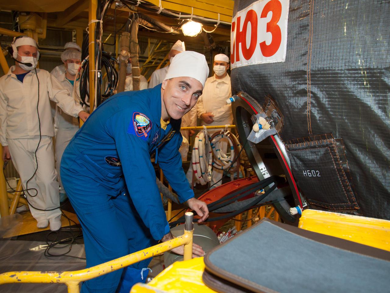 In the Integration Facility at the Baikonur Cosmodrome in Kazakhstan, Expedition 35-36 Flight Engineer Chris Cassidy of NASA climbs into his Soyuz TMA-08M spacecraft March 17 for a systems dress rehearsal called a “fit check”. Cassidy, Soyuz Commander Pavel Vinogradov and Flight Engineer Alexander Misurkin are preparing for launch to the International Space Station from Baikonur on March 29, Kazakh time. NASA/Victor Zelentsov