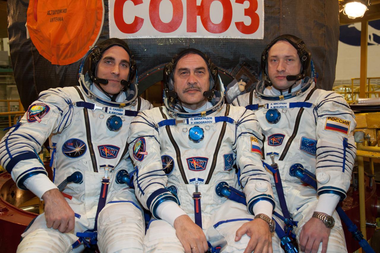In the Integration Facility at the Baikonur Cosmodrome in Kazakhstan, the Expedition 35-36 prime crewmembers pose for pictures March 17 during a systems dress rehearsal called a “fit check”. Left to right are NASA Flight Engineer Chris Cassidy, Soyuz Commander Pavel Vinogradov and Flight Engineer Alexander Misurkin. Cassidy, Vinogradov and Misurkin are preparing for launch to the International Space Station from Baikonur on March 29, Kazakh time. NASA/Victor Zelentsov