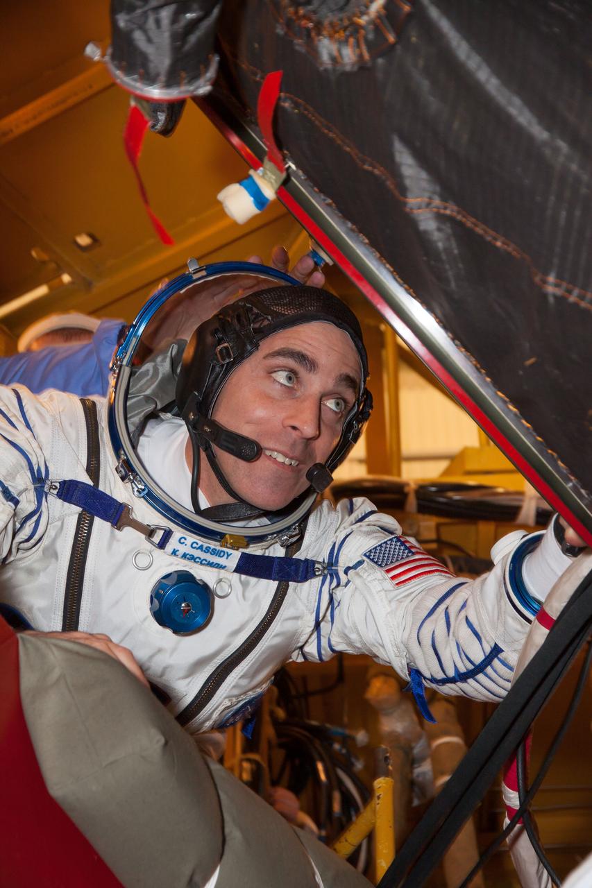 In the Integration Facility at the Baikonur Cosmodrome in Kazakhstan, Expedition 35-36 Flight Engineer Chris Cassidy of NASA climbs into his Soyuz TMA-08M spacecraft March 17 for a systems dress rehearsal called a “fit check”. Cassidy, Soyuz Commander Pavel Vinogradov and Flight Engineer Alexander Misurkin are preparing for launch to the International Space Station from Baikonur on March 29, Kazakh time. NASA/Victor Zelentsov