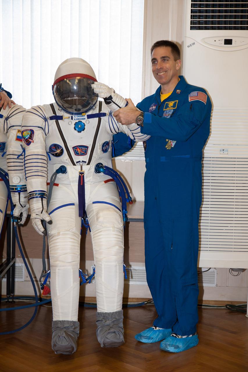 In the Integration Facility at the Baikonur Cosmodrome in Kazakhstan, Expedition 35-36 Flight Engineer Chris Cassidy of NASA has a playful moment with his Russian Sokol launch and entry suit March 17 during a systems dress rehearsal called a “fit check”. Cassidy, Soyuz Commander Pavel Vinogradov and Flight Engineer Alexander Misurkin are preparing for launch to the International Space Station from Baikonur on March 29, Kazakh time. NASA/Victor Zelentsov