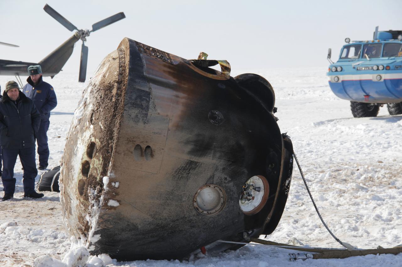 The Soyuz TMA-06M spacecraft lies passively on its side March 16 after bringing home Expedition 34 Commander Kevin Ford of NASA, Soyuz Commander Oleg Novitskiy and Flight Engineer Evgeny Tarelkin to a landing northeast of Arkalyk, Kazakhstan following a one-day delay due to inclement weather in the area. The Soyuz initially landed upright before being tilted on its side for servicing after touching down to wrap up 144 days in space and 142 days for Ford, Novitskiy and Tarelkin at the International Space Station. The three crewmembers were flown by helicopter to Kustanai, Kazakhstan en route to their homes in Houston and Star City, Russia.  Courtesy of Sergey Vigovskiy 