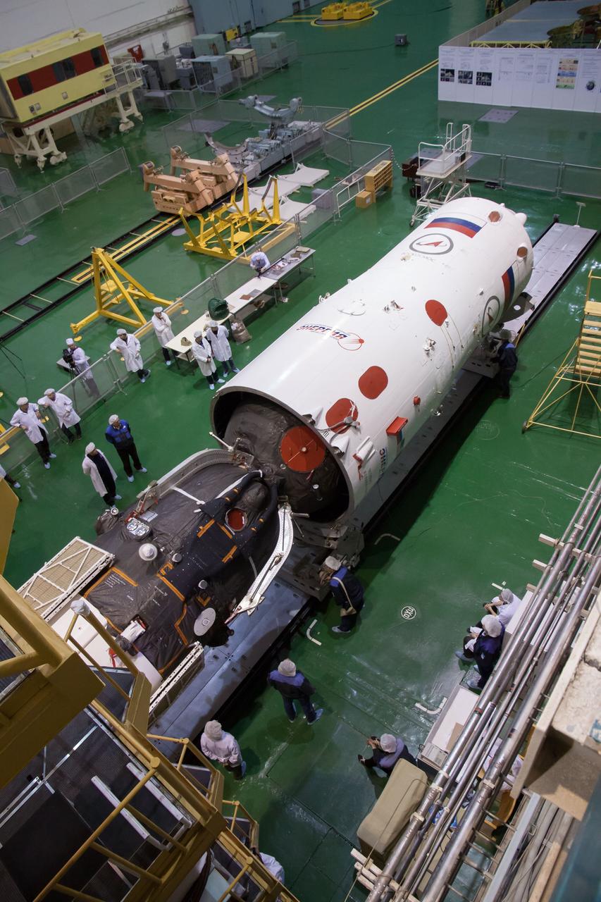 At the Integration Facility at the Baikonur Cosmodrome in Kazakhstan, the Soyuz TMA-08M spacecraft is encapsulated into the third stage of a Soyuz booster rocket March 22. The operation was part of the preparation for the Soyuz’ launch March 29, Kazakh time, to carry Expedition 35/36 Flight Engineer Chris Cassidy of NASA, Soyuz Commander Pavel Vinogradov and Flight Engineer Alexander Misurkin to the International Space Station for a 5 ½ month mission.  NASA/Victor Zelentsov 