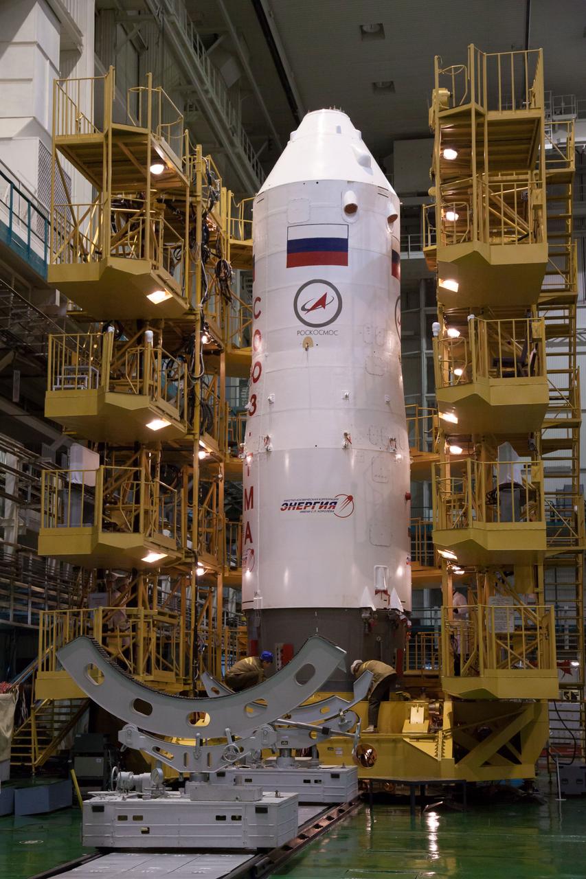 With the Soyuz TMA-08M spacecraft safely nestled inside, the upper stage of a Soyuz booster rocket stands at the ready in the Integration Facility at the Baikonur Cosmodrome in Kazakhstan following the encapsulation of the Soyuz vehicle March 22. The operation was part of the preparation for the Soyuz’ launch March 29, Kazakh time, to carry Expedition 35/36 Flight Engineer Chris Cassidy of NASA, Soyuz Commander Pavel Vinogradov and Flight Engineer Alexander Misurkin to the International Space Station for a 5 ½ month mission.  NASA/Victor Zelentsov 