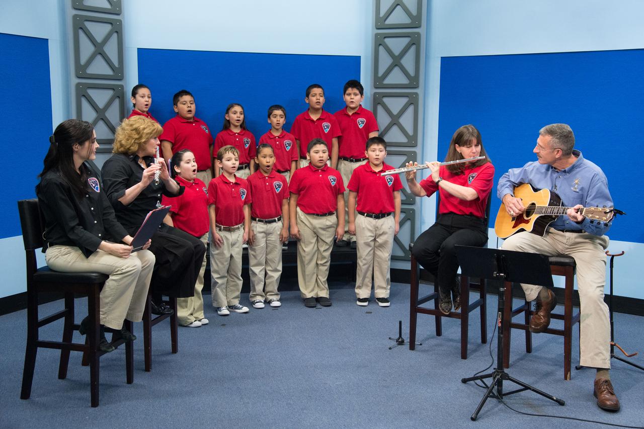 jsc2013e020086 (3/27/2013) --- JSCs Digital Learning Network hosts a live International Space Station (ISS) downlink with students from the Pasadena Independent School Districts Pearl Hall Elementary as they explore the many cultures and music surrounding the ISS partners. The Music and Space event is hosted by Astronaut Cady Coleman. Students perform songs at the JSC DLN studio with Astronauts Coleman and Dan Burbank who perform with flute and guitar.