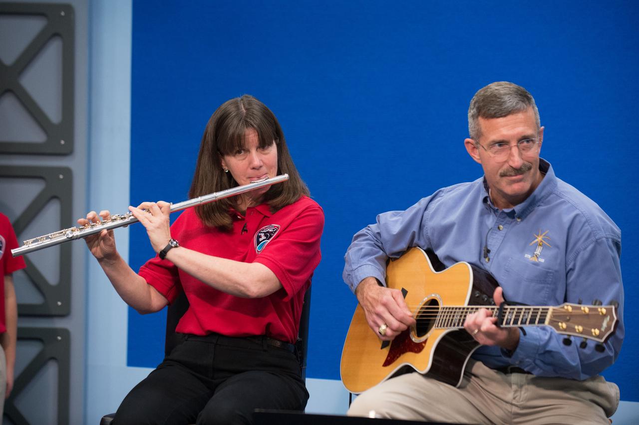 jsc2013e020091 (3/27/2013) --- JSCs Digital Learning Network hosts a live International Space Station (ISS) downlink with students from the Pasadena Independent School Districts Pearl Hall Elementary as they explore the many cultures and music surrounding the ISS partners. The Music and Space event is hosted by Astronaut Cady Coleman. Students perform songs at the JSC DLN studio with Astronauts Coleman and Dan Burbank who perform with flute and guitar.