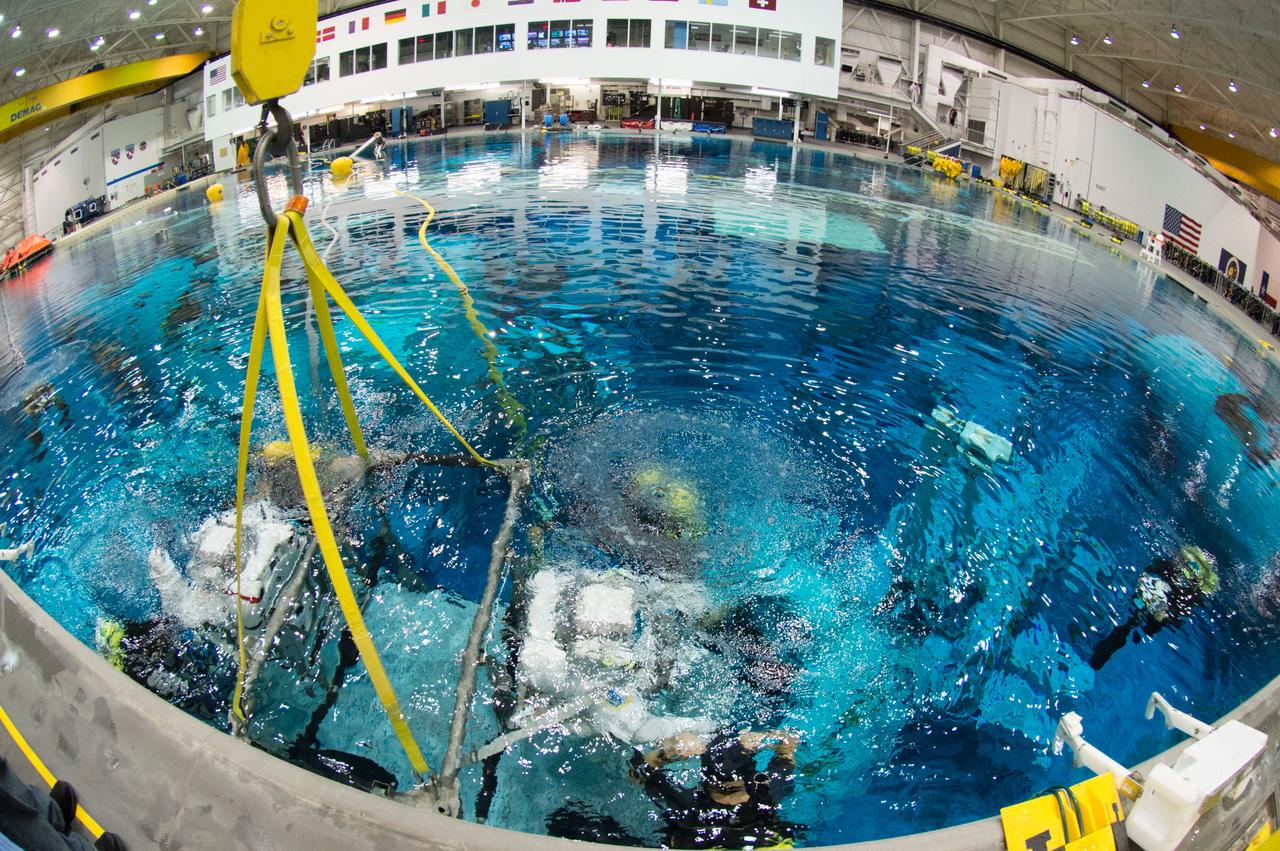 PHOTO DATE:  03-28-13 LOCATION:  NBL - Pool Topside  SUBJECT:  Expedition 39 (Soyuz 37) crew members Rick Mastracchio and Koichi Wakata during pre-dive briefing, preparations and suitup, then lowering into the water. PHOTOGRAPHER: BILL STAFFORD