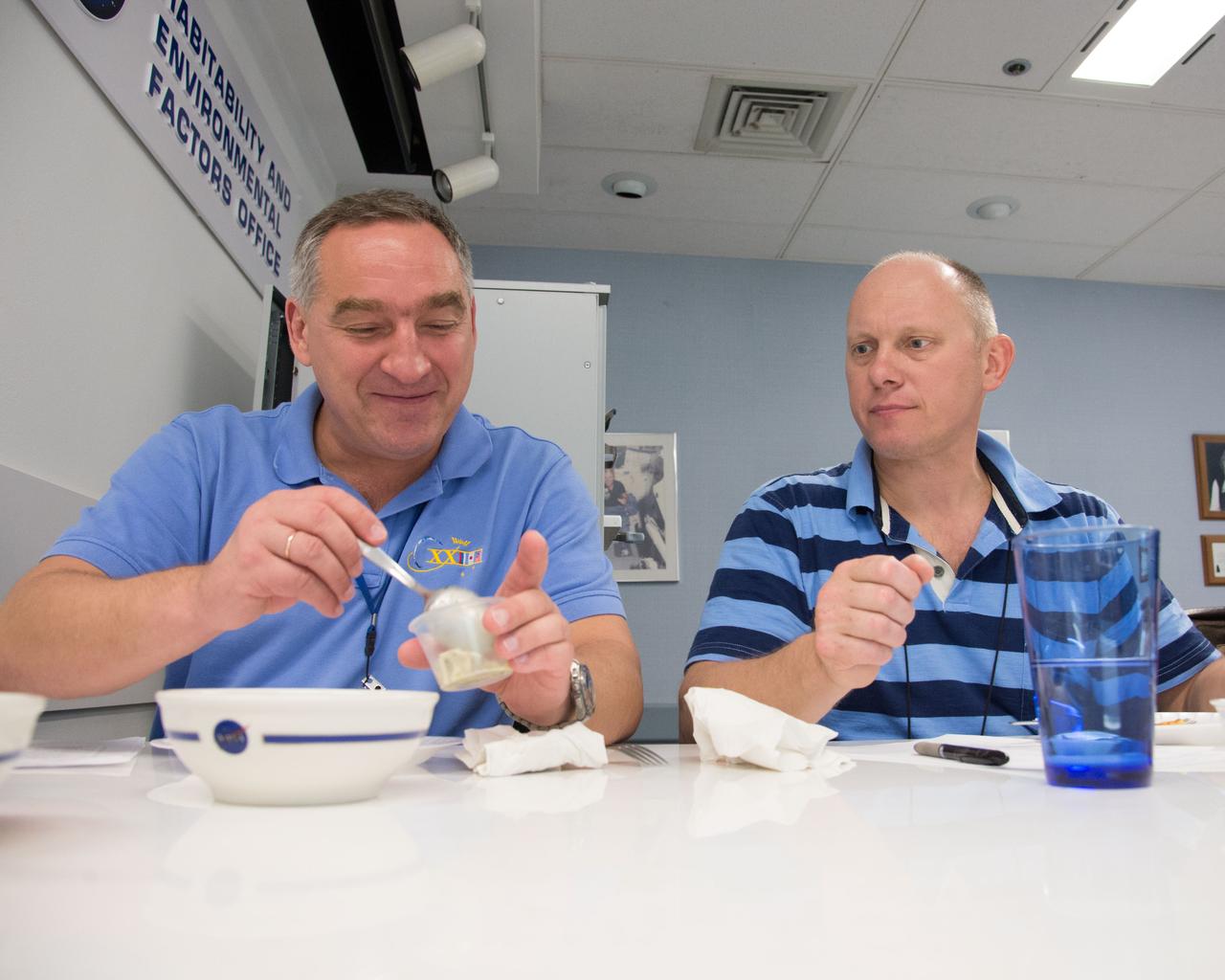 PHOTO DATE: 04-26-13 LOCATION: Bldg. 17, Rm 1070 - Food Lab SUBJECT: Soyuz 38 (Expedition 39/40) crew members Alexander Skvortov and Oleg Artemiev during food tasting in JSC Food Lab. Photograph cosmonauts individually, with food lab personnel, together, etc. PHOTOGRAPHER: BILL STAFFORD