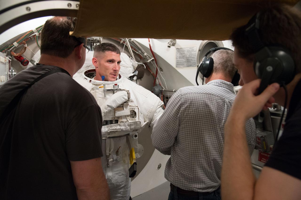 PHOTO DATE: 25 April 2013 LOCATION: Bldg. 7, SSATA Chamber SUBJECT: Astronaut Mike Hopkins during SSATA ISS Increment 39 EMU Dry Run Certification. Astronaut and fellow crew member Steve Swanson assists. PHOTOGRAPHER: Mark Sowa