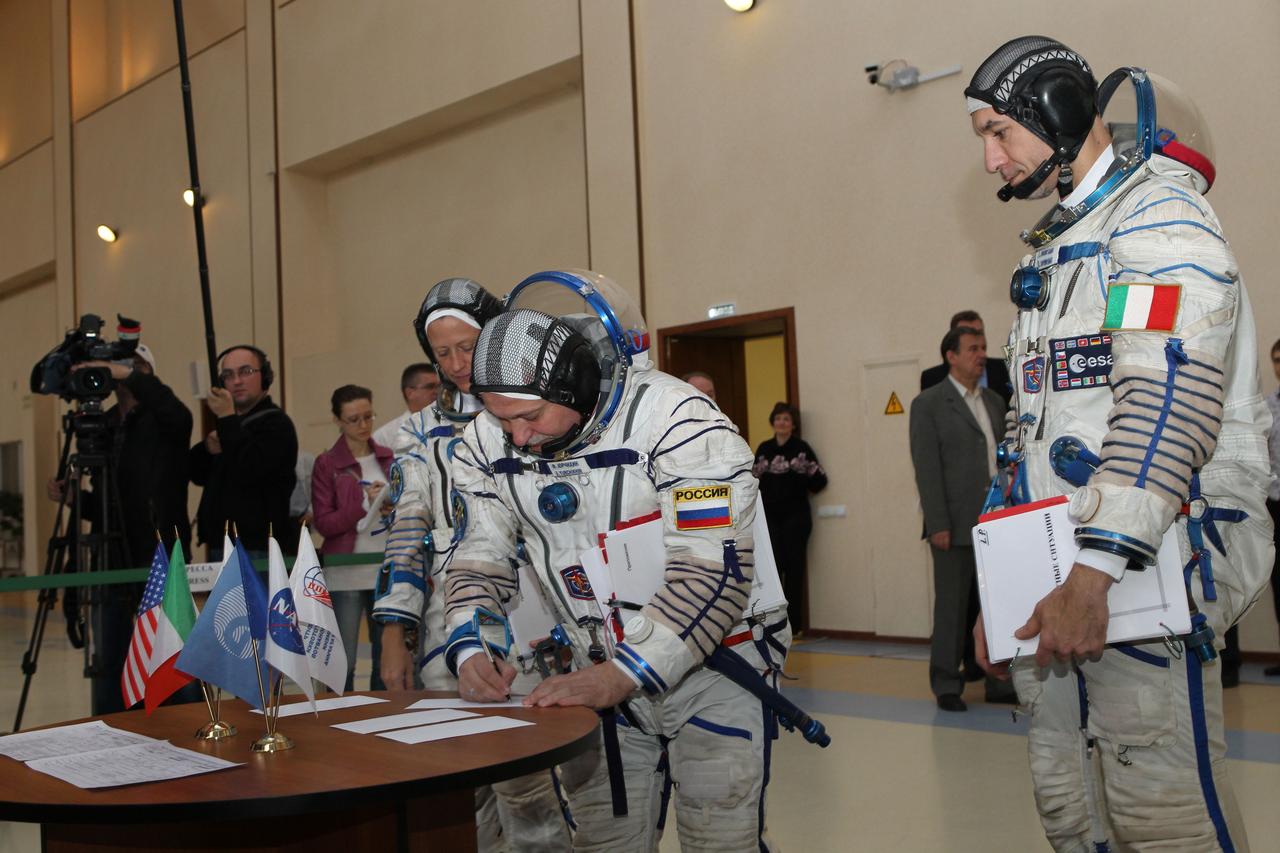 At the Gagarin Cosmonaut Training Center in Star City, Russia, Expedition 36/37 Soyuz Commander Fyodor Yurchikhin signs in for the start of final qualification training April 30 as his crewmates, NASA Flight Engineer Karen Nyberg (left) and Luca Parmitano of the European Space Agency (right), look on. The three crewmembers are training for their launch May 29, Kazakh time, in their Soyuz TMA-09M spacecraft from the Baikonur Cosmodrome in Kazakhstan for a 5 ½ month mission on the International Space Station. NASA/Stephanie Stoll