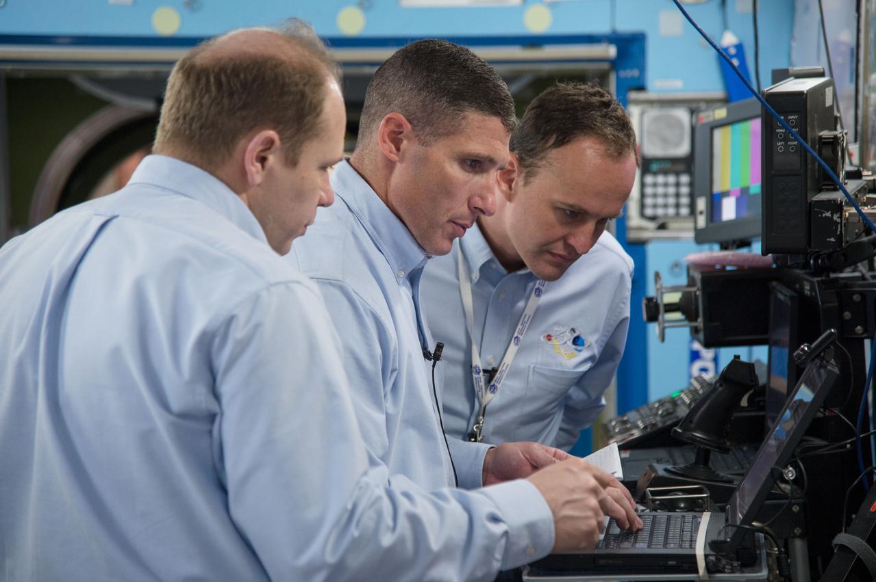 PHOTO DATE: 5-3-13 LOCATION: Bldg. 9NW - ISS Mockups SUBJECT: Soyuz 36 crew (Oleg Kotov, Sergey Ryazanskiy and Michael Hopkins) in their Routine Ops training. PHOTOGRAPHER: Lauren Harnett