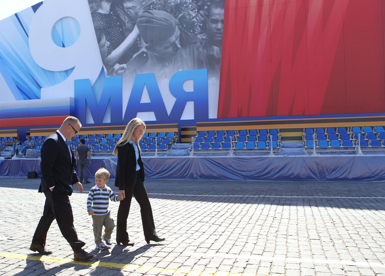 Expedition 36/37 Flight Engineer Karen Nyberg (right) takes a stroll through Red Square in Moscow May 8 in front of a grandstand with her husband, astronaut Doug Hurley (left) and their son. Red Square was decorated for commemorative activity in honor of Russian Victor Day May 9. Nyberg, Soyuz Commander Fyodor Yurchikhin and Flight Engineer Luca Parmitano of the European Space Agency are preparing for their launch May 29, Kazakh time, in their Soyuz TMA-09M spacecraft from the Baikonur Cosmodrome in Kazakhstan for a six-month mission on the International Space Station. NASA/Stephanie Stoll
