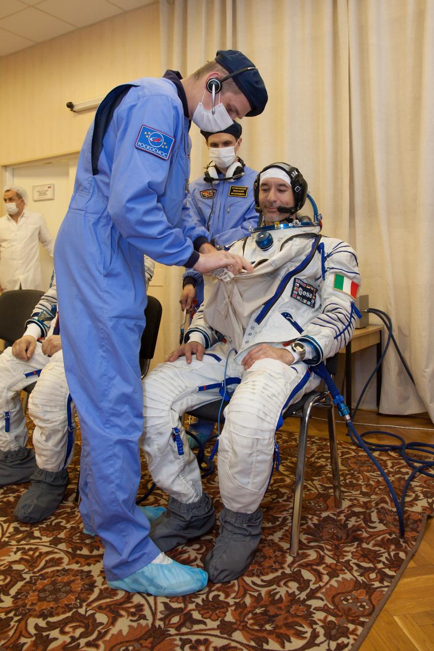 In the Integration Facility at the Baikonur Cosmodrome in Kazakhstan, Expedition 36/37 Flight Engineer Luca Parmitano of the European Space Agency suits up for a dress rehearsal exercise May 17 during a suited “fit check”. Parmitano, NASA Flight Engineer Karen Nyberg and Soyuz Commander Fyodor Yurchikhin will launch May 29, Kazakh time, in their Soyuz TMA-09M spacecraft to begin a 5 ½ mission on the International Space Station. NASA/Victor Zelentsov